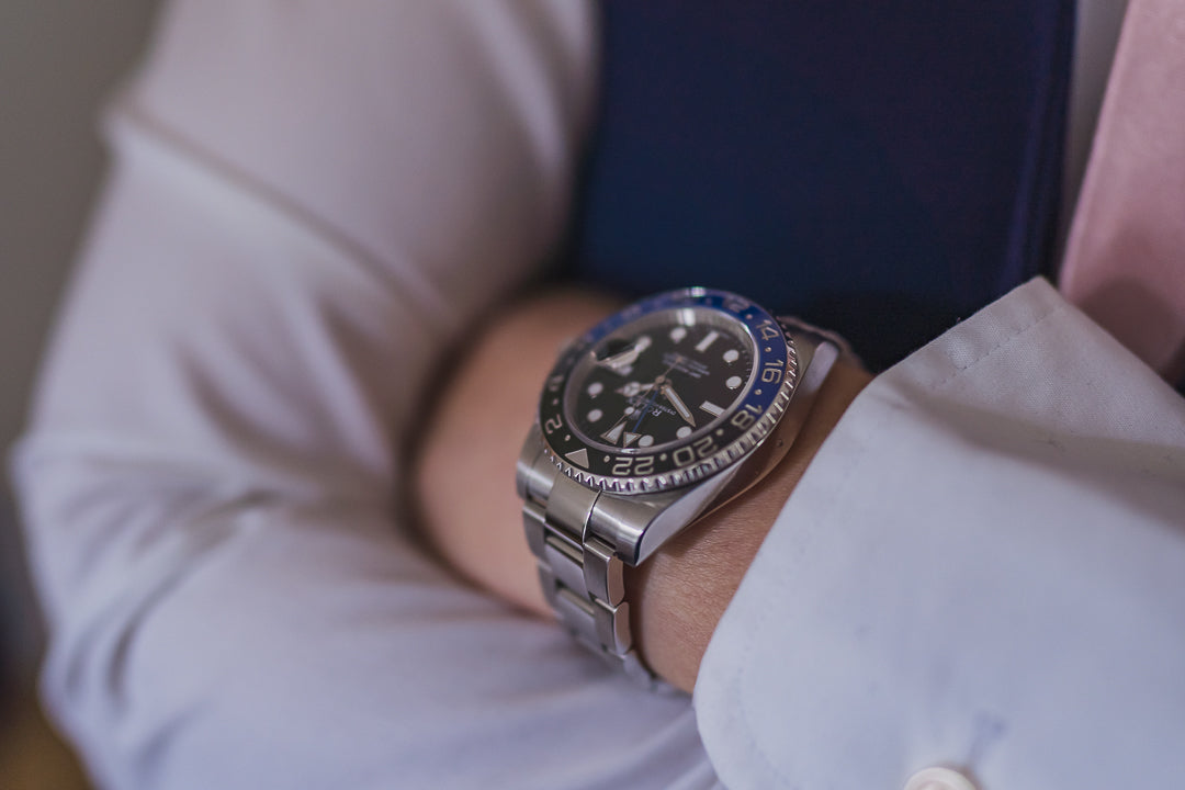 A close up of a luxury Rolex watch on a mans wrist